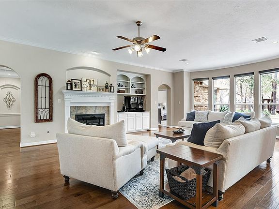 Open living room with natural lighting and views of the backyard.