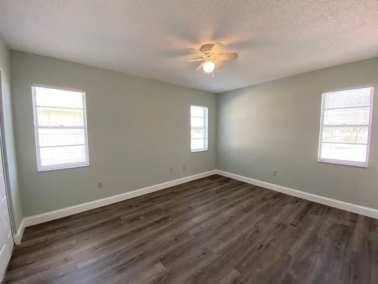 Master bedroom has an abundance of natural light with three windows.