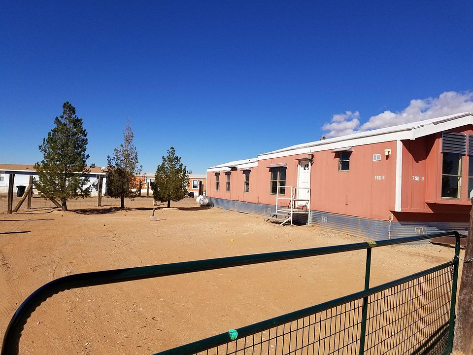 Spacious front yard with fenced and gated area.
