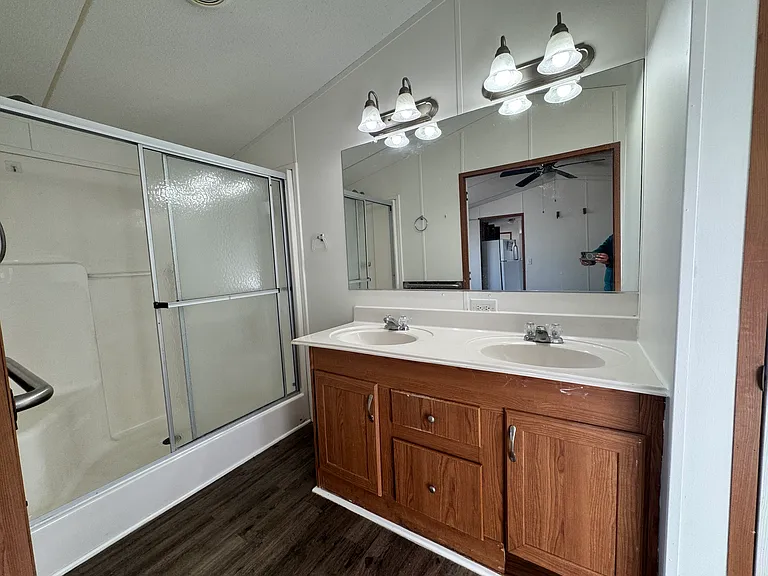 Principal's bathroom with shower, double vanity, linen closet and more
