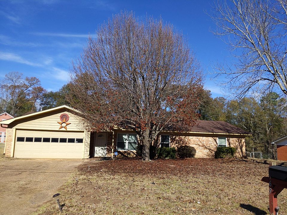 Mature tree and 2 car garage.