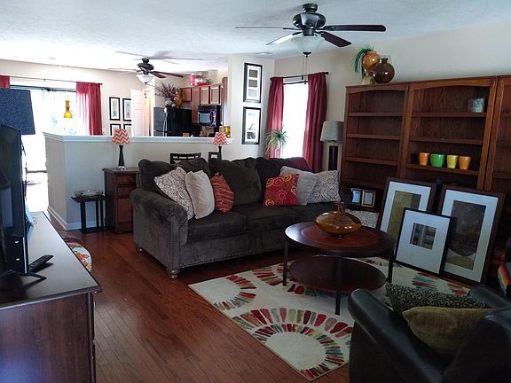 From front porch entry, open living room & kitchen to patio, large back yard and back view of farmland, half bath and master suite to left.