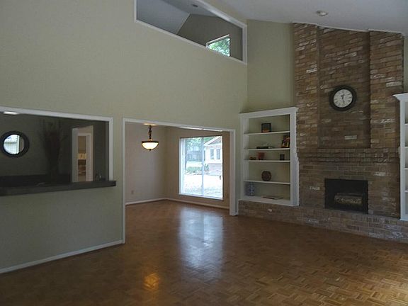 Shot of the living room with the loft upstairs, and a peek into the dining room