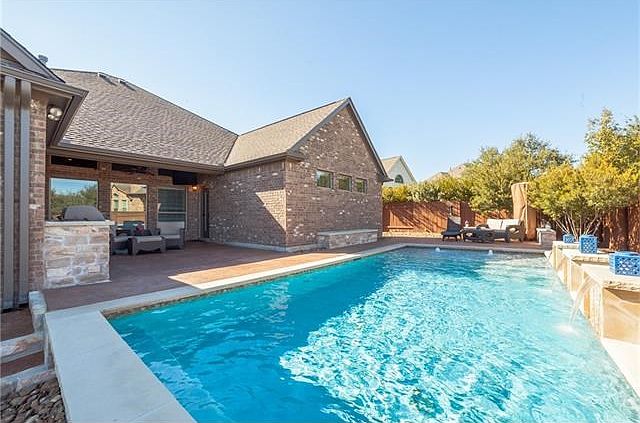 This gorgeous one-story home has it all! The large outdoor living space with amazing patio, built-in