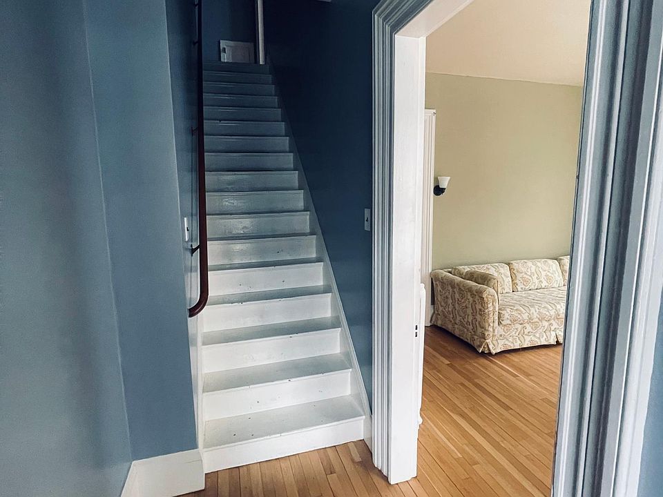 Looking in from the front entrance. Living room on right, stairs to the second floor strait ahead.