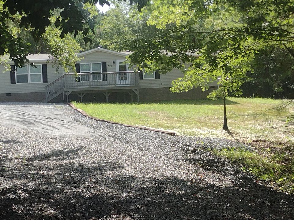 Wide driveway with off-street parking for many cars. Newly planted lawn coming in.