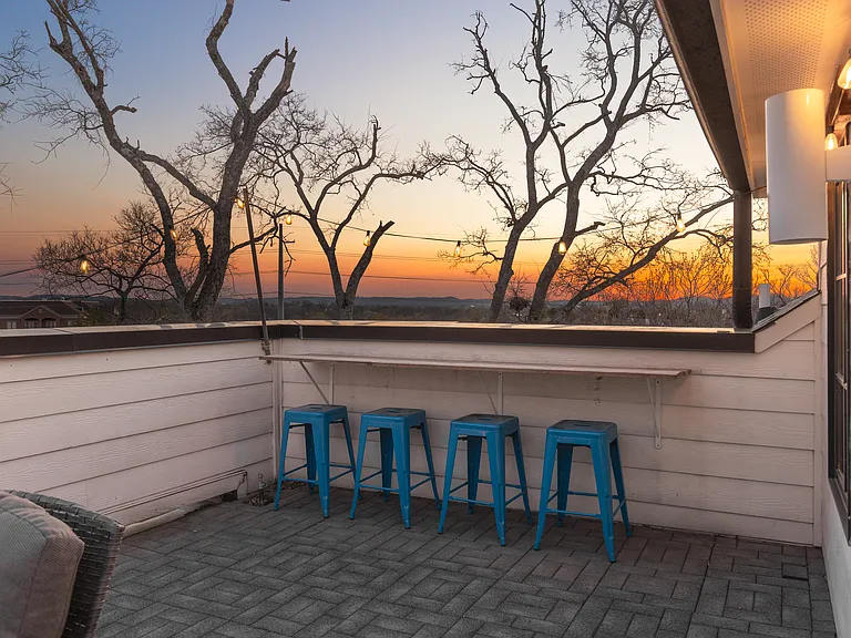 Private rooftop deck with plenty of seating and outdoor lights, allowing you to enjoy your morning cup of coffee or a late night conversation while overlooking the skyline.