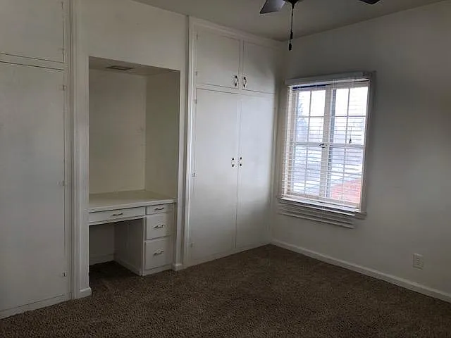 Bedroom (view 2) showing build in closets and dresser