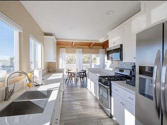 Large Kitchen with all stainless steel appliances, Stove, Microwave, Dishwasher, Double Sink with pullout faucet, and tons of storage