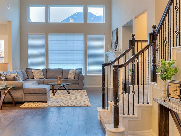 Natural light streams into the living area from the wall of windows.
