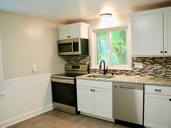 Kitchen with new appliances, back splash, granite counter, new cabinets and floors
