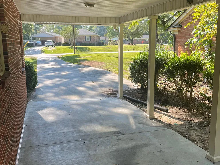 Attached carport and concrete driveway