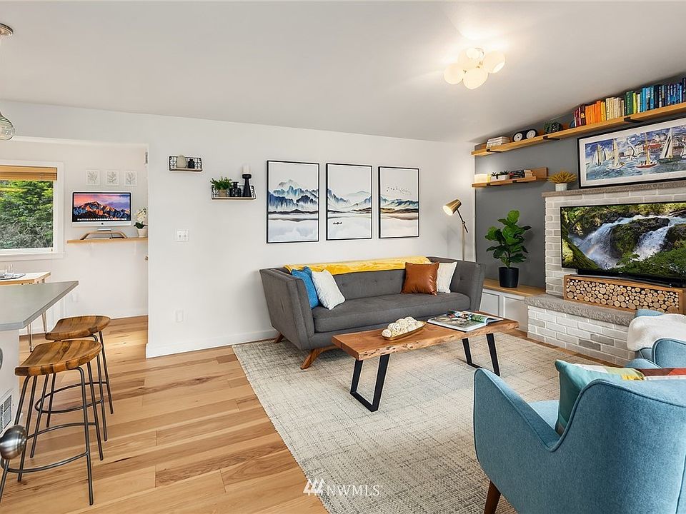 Enter to living room with custom shelving and thoughtfully designed bench seats with storage.