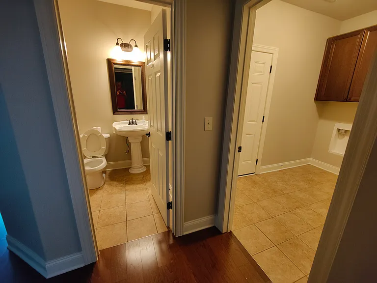 Guest bathroom is between formal dining room and kitchen, next to laundry room.