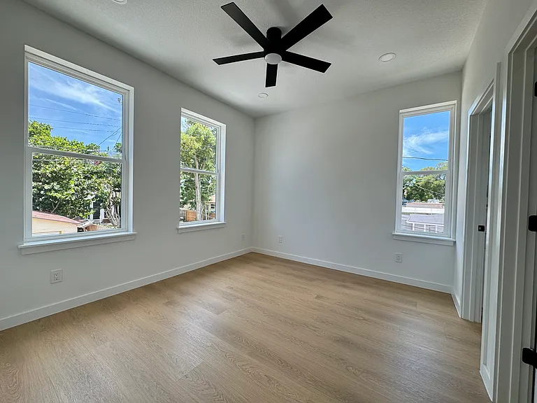 Spacious bedroom with large windows.