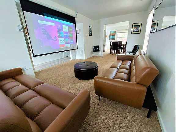 Living Room with 2 Futons & 92" Projector Screen