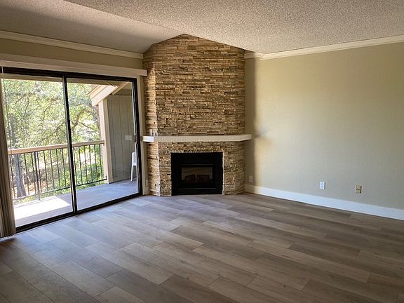 Living Room with a "View & a Balcony"!
Stacked Stone Fireplace with a easy turn on and off remote. Flooring is a rich earth tone Vinyl plank style. crown molding and updated overhead lighting.