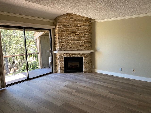 Living Room with a "View & a Balcony"!
Stacked Stone Fireplace with a easy turn on and off remote. Flooring is a rich earth tone Vinyl plank style. crown molding and updated overhead lighting.