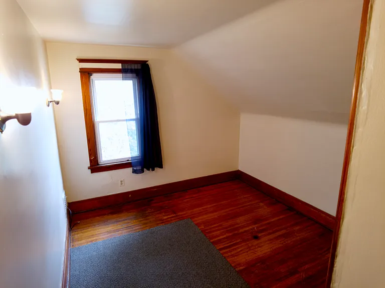 Bedroom with original hardwood floors.