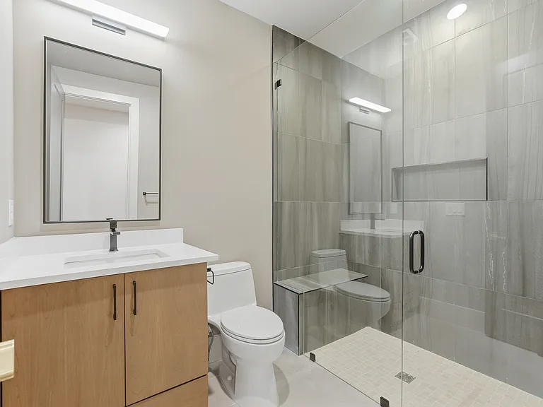 Modern bathroom with glass enclosed shower and sleek finishes