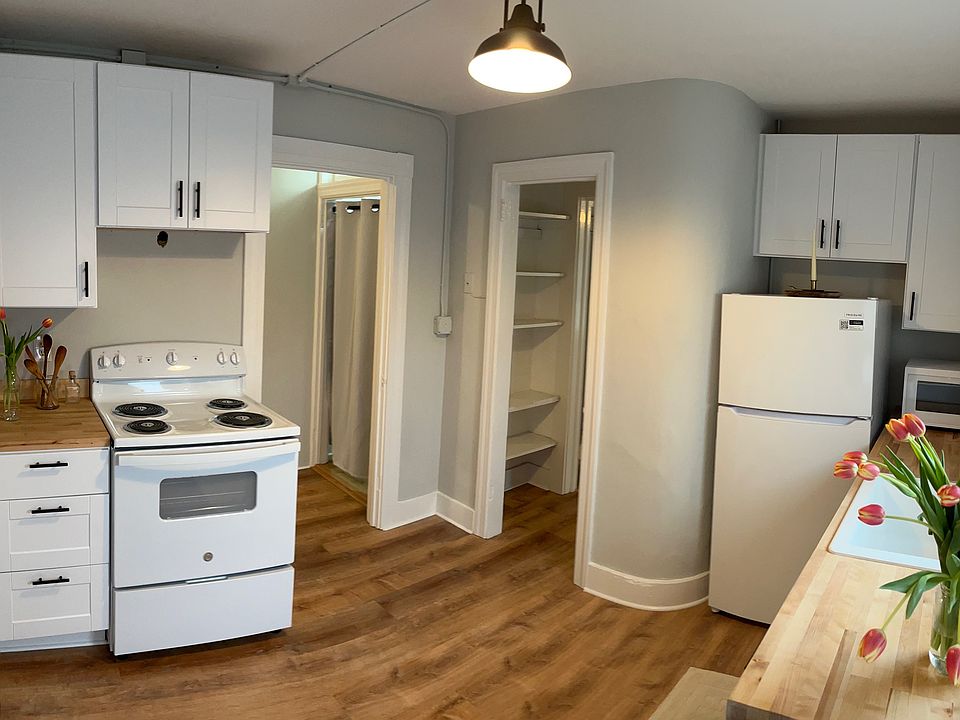 Recently renovated Kitchen with butcher block countertops, electric stove, fridge, and microwave