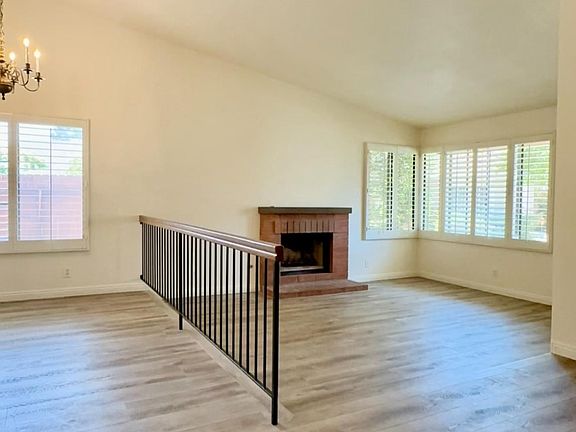 Partial photo of dining area, and living room with fireplace