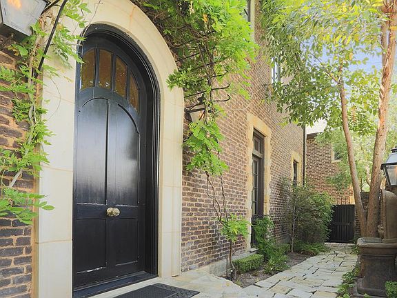 For privacy, the front door is located on the South side of the residence along a stone walking path