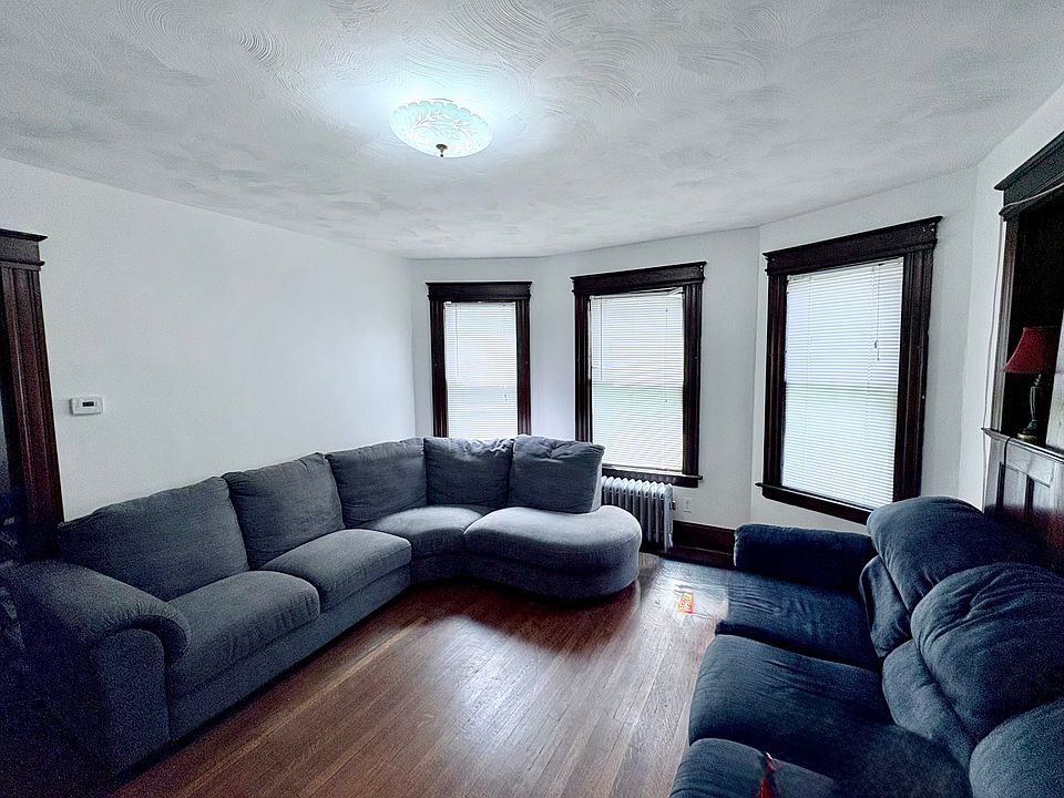 This is the dining room. Furniture shows the size. There are built in cabinets. It opens on one side to the living room that has large windows. This room also has an entrance to the kitchen & family room.
