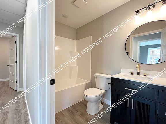 Hall bathroom. This unit is still under construction. Photo of neighboring unit with similar finishes.