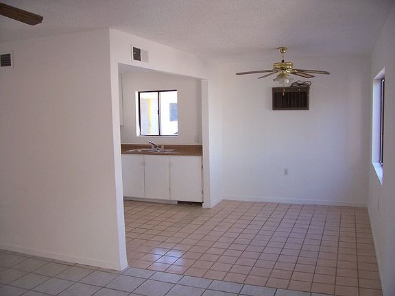 Dining room area - Tile floor, ceiling fan, window for light and air.