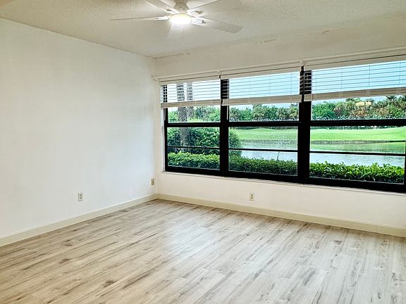 Gorgeous brand new luxurious vinyl plank floors throughout + STUNNING expansive lake & golf course views to enjoy!