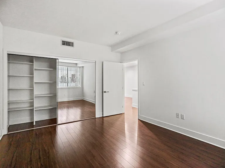 Bedroom with Closet with Built-In Shelving