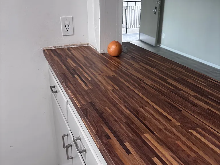 Walnut wood bar open to dining room.