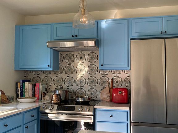 Spanish Tile Backsplash with lovely natural light, Induction Range