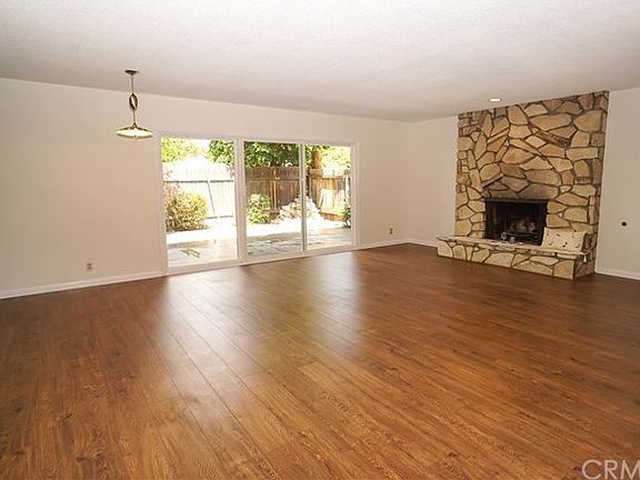 Huge living room with new dual pane slider doors to backyard patio.  Fireplace works wel  with gas and/or wood.  New wood laminate flooring