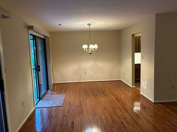 Dining room area adjacent to deck on left and entrance to kitchen on right.
