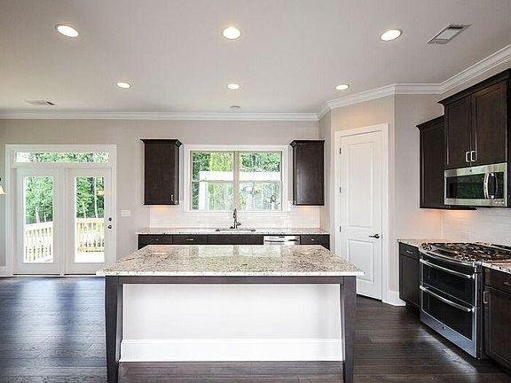 Double deck oven, gas stove top, refrigerator, granite top kitchen island