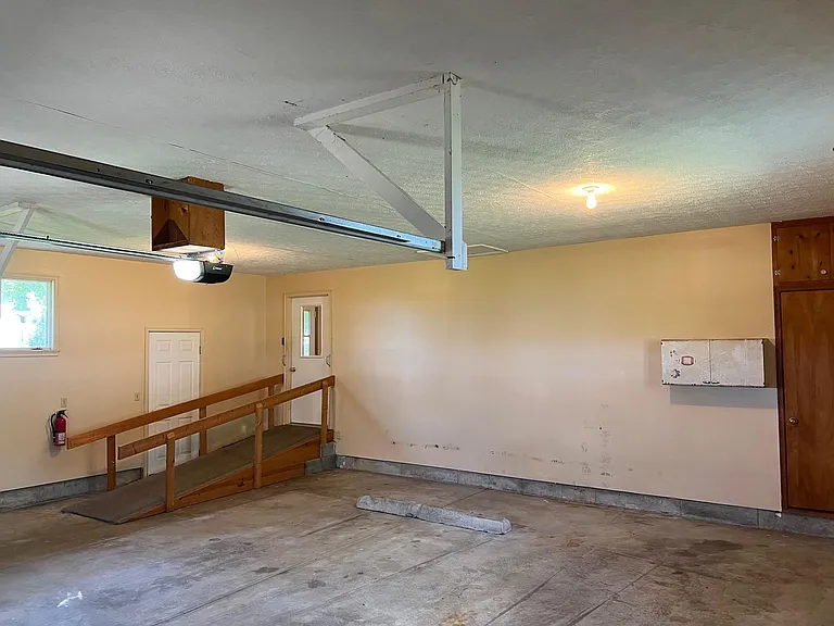 Garage
Handicap ramp
Mounted 2 door cabinet 
Large, deep closet (door on right side)
Parking bumper
High windows to let in light, but not low enough to look into