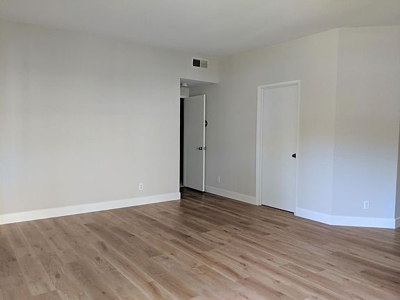 Open door to hallway with main bedroom and walk-in closet. Closed door to an office (10' x 10').