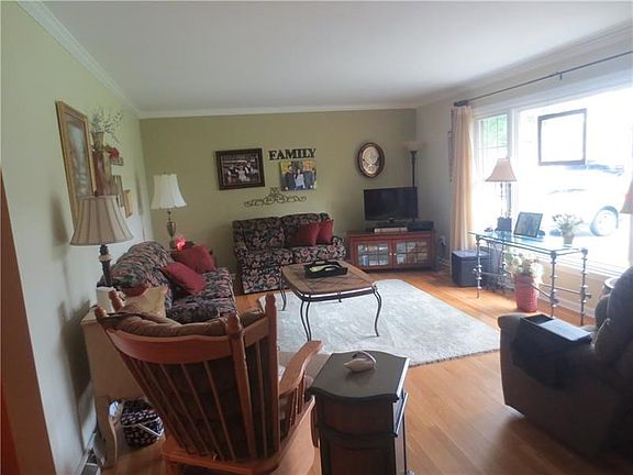 Huge living room with crown moulding and lovely hardwood floors.
