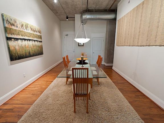  View from kitchen back toward front of unit. Door to left is entry from building hallway. The neutral palette and textures bring a calming sense to the room.