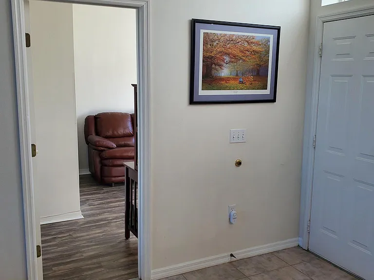 Door to office with treadmill, spin bike and sofa bed.