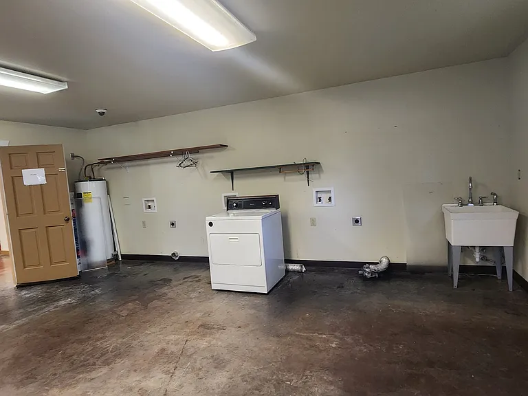 Cabin addition is currently used for owner storage. Set up available for laundry facility with three washer and dryer hookups. Utility sink. Window unit heat/AC.

Secured door that may or may not be used to access foyer/office.