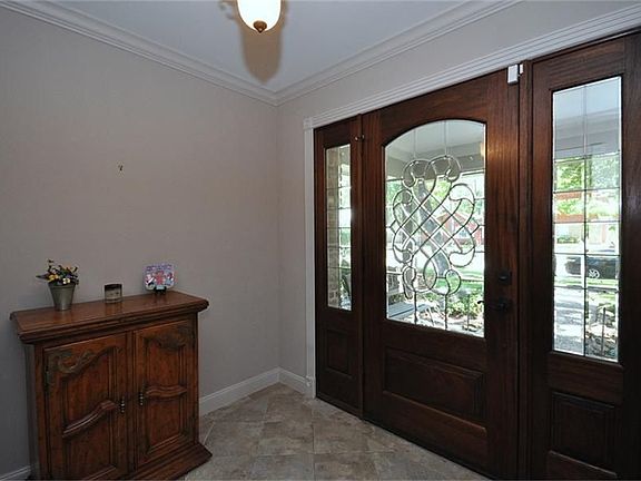 Pretty bevel glass door and stone tiles in entry!
