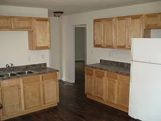 Kitchen sink and refrigerator, looking toward hallway and bedroom #2