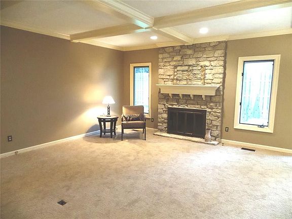 The Great room has an electric outlet in the floor so that furniture arranging can be varied. Enjoy the gas fireplace and views to the back