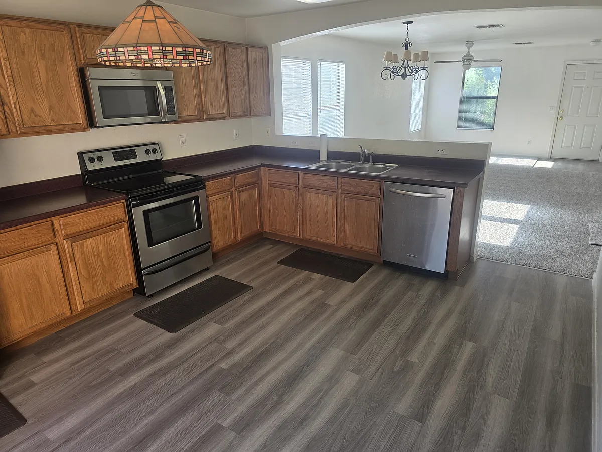 Modern kitchen with ample counter space, island seating, and all appliances included. - 2435 W Mobile Ln