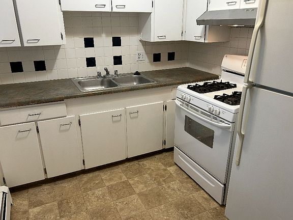 Nice kitchen with gas cooking stove 
Door in the kitchen leads to outside