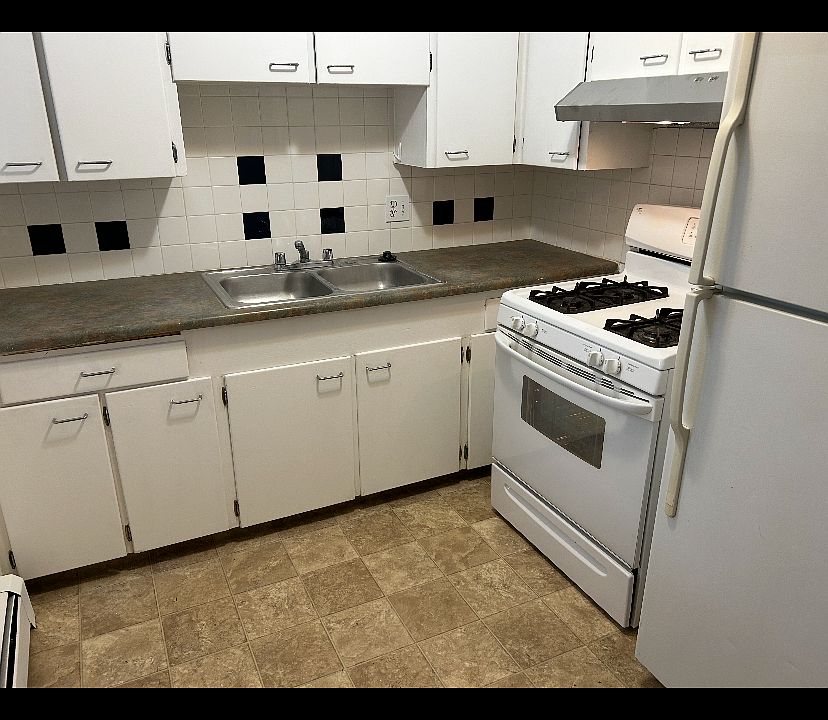 Nice kitchen with gas cooking stove 
Door in the kitchen leads to outside