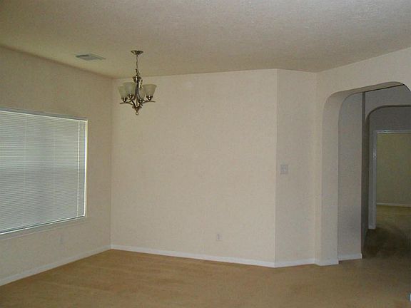 The living room/family room is huge at 20.10x14.6 feet. The chandelier indicates possibly a dining/l